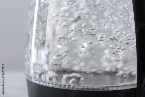 Fotomural Transparent electric kettle with boiling water, closeup