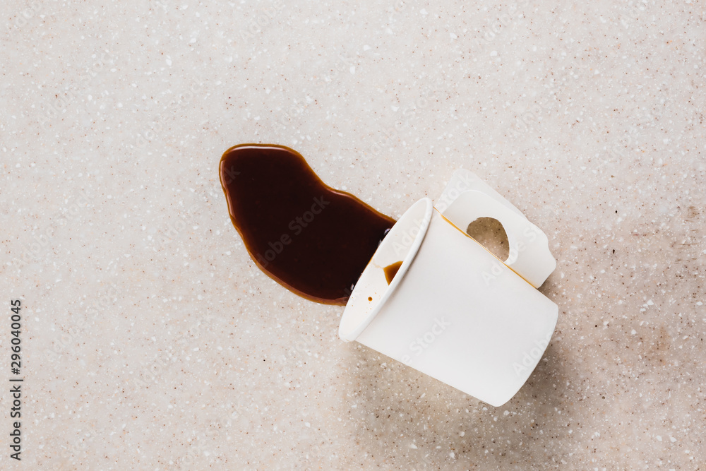 split coffee from a paper cup on terrazzo stone table, top view with ...