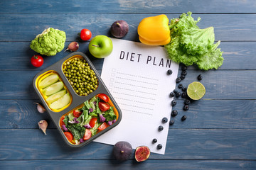 Wall Mural - Sheet of paper with diet plan and healthy products on wooden table