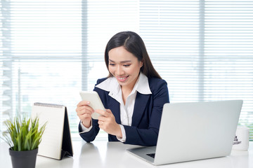 Wall Mural - Executive working on line with a laptop and phone in a desktop at office