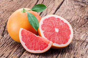 Wall Mural - Grapefruits on old wooden background.