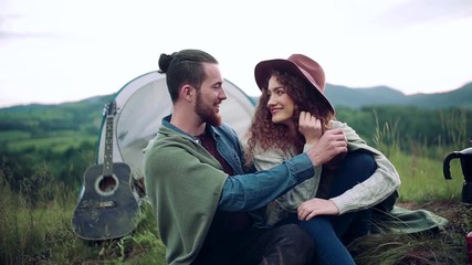 Wall Mural - young tourist couple travellers with tent shelter sitting in nature, resting.