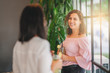 © Sondem - Womans chatting and smiling while they staying and drinking some beverage