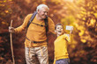 © Mediteraneo - Grandfather and grandson hiking together in autumn park, make selfie photo.