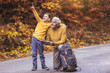 © Mediteraneo - Senior man reading map on digital tablet with grandson in forest walk.