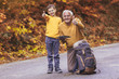© Mediteraneo - Senior man with grandson in forest walk, showing thumbs up.