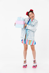 Sticker - Image of excited nice woman holding gift boxes and smiling