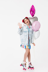 Canvas Print - Image of joyful young woman waving hand and holding balloons