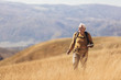 © Mediteraneo - Senior man on hike through beautiful countryside in autumn.