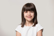 © fizkes - Headshot portrait of happy little girl posing in studio