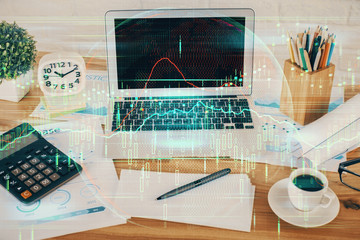 Multi exposure of graph and financial info and work space with computer background. Concept of international online trading.