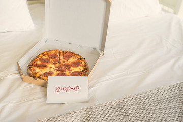 Wall Mural - Open box of pizza on the big bed and card with Quote - xo xo xo. Valentine lettering love collection. Concept