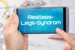 Smartphone mit dem Text Restless-Legs-Syndrom auf dem Display