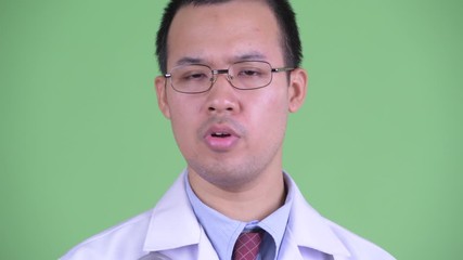 Wall Mural - Face of serious Asian man doctor nodding head no