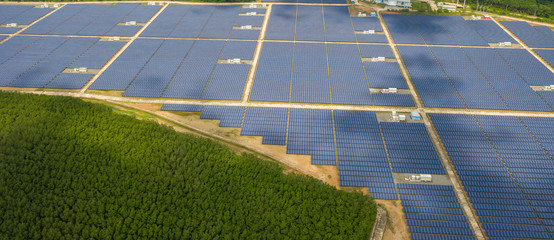 aerial view ,solar power plants have clouds moving through and sunlight shines. banner background
