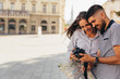 Leinwanddruck Bild - couple tourist in sightseeing in city using photo camera