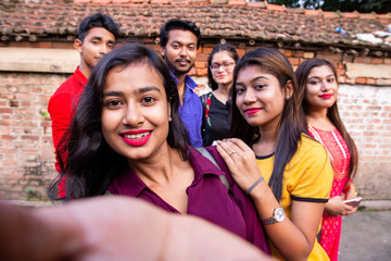 Best friends multiracial people taking selfie outdoor - Happy friendship concept with young students having fun together - Peace love against racism - International exchange experience - Warm filter