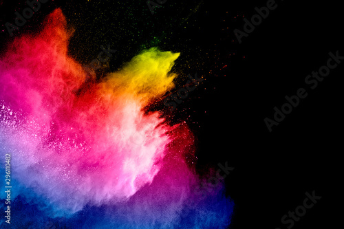Colorful powder explosion on black background. Abstract pastel color dust par...