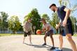 © Syda Productions - sport, leisure games and male friendship concept - group of men or friends playing street basketball