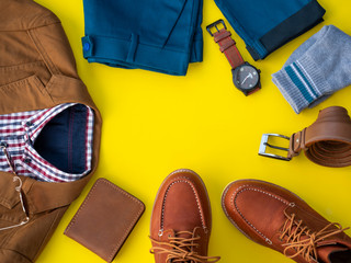 Wall Mural - Men fashion clothing set and accessories isolated on a yellow background. Office clothes concept, Top view