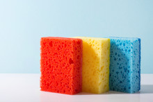 Multi-colored Dishwashing Sponges On A Blue Background