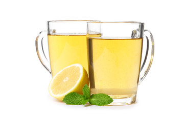 cup of hot tea with ginger, lemon and mint isolated on a white background