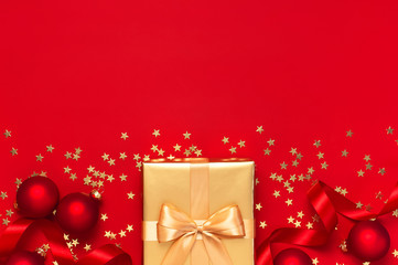 Wall Mural - Flat lay Xmas holiday 2020 celebration. New Year Christmas golden presents with ribbon, Christmas balls, gold confetti stars on red background top view. Gift boxes greeting card Festive decorations