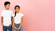 © Prostock-studio - Young friends posing, guy looking at girl over pink background