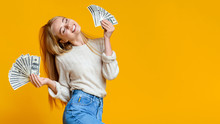 Blissful Millennial Girl Holding Lots Of Money And Enjoying Success