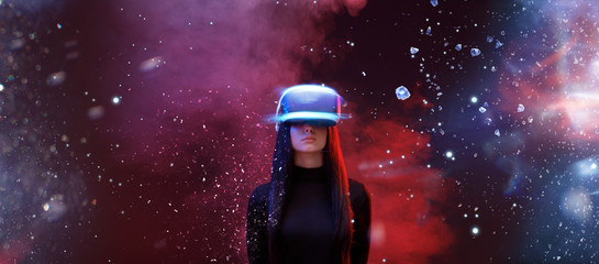 beautiful woman with flowing hair in futuristic dress over dark space magic background. girl in glas