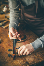 Luthier Repair Violin In His Workshop