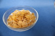© Кристина Шоба - cornflakes in bowl plate on blue background