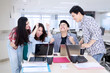 © Creativa Images - Business team clenched fist to celebrating success