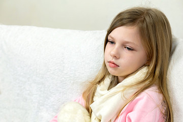 a sick little girl takes medication and eats fruit.