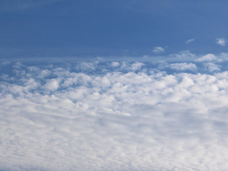 Summer background with white flying clouds on blue sky. Romantic natural heaven backdrop. 