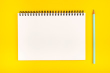 Empty Notebook And Pencil On Yellow Background, Top View. Copy Space.