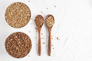 buckwheat green and plain on a white background top view two wooden spoons