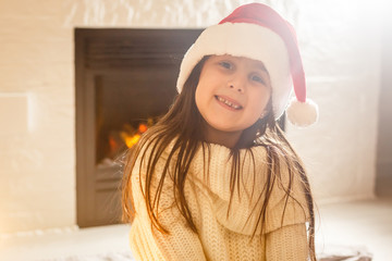 Wall Mural - Cute little girl in the santa claus hat