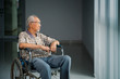 © Creativa Images - Senior man sits in the wheelchair near the window