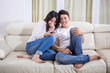 © Creativa Images - Young happy couple watching television at home