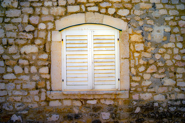 old wooden door in the vintage stone wall