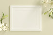 empty white picture frame for insert text or image inside with white flower decorate on yellow pastel color..