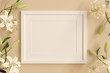 © justyle - empty white picture frame for insert text or image inside with white flower decorate on orange pastel color..