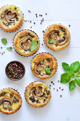 Wall Mural - Tartlets with mushrooms and chicken on a wooden background. View from above.