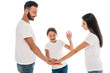 © LIGHTFIELD STUDIOS - positive family putting hands together isolated on white