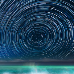 Wall Mural - star-trails above the caribbean sea, in jamaica, with the northern star in the center of the image.