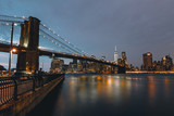 Fototapeta Londyn - Brooklyn Bridge with New York City Skyline in the Background with One World Trade and Skyline at Night