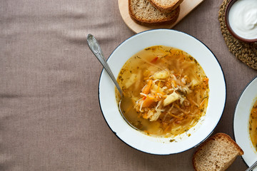 Wall Mural - Traditional russian vegetable soup with sour cabbage in a white bowl