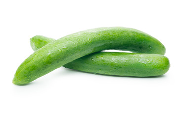 Two cucumbers with water drop,  overlapping on a white background with clipping path.