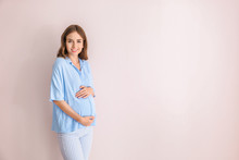 Beautiful Pregnant Woman On Light Background